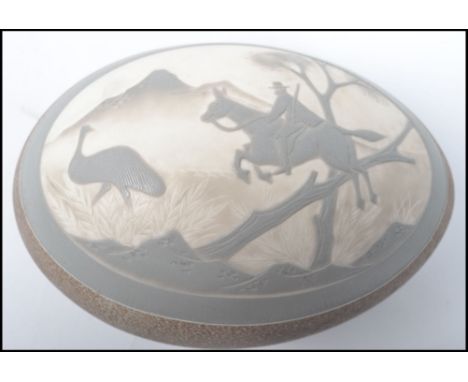 A 19th century carved / etched emu egg having a oval cameo depicting a man on horse hunting an ostrich in relief. Measures 15