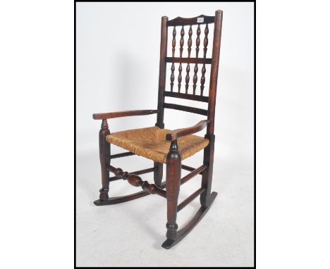 A 19th century North Country - Lancashire country oak ladderback rocking chair / armchair being raised on sleigh runners with