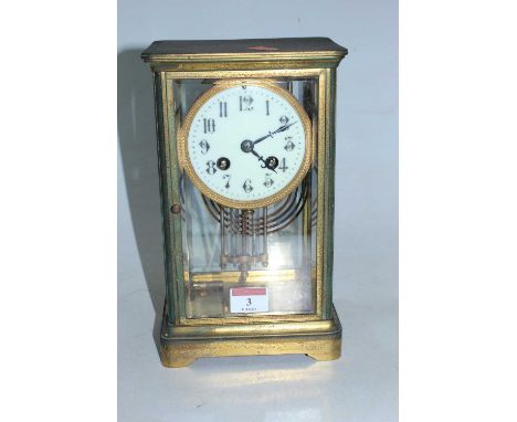 A late 19th century lacquered brass cased four glass mantel clock, having a circular enamel dial with Arabic numerals and eig
