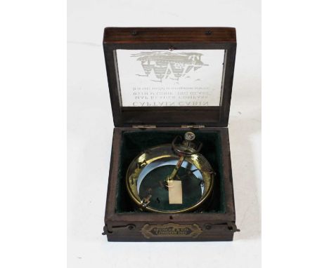 A reproduction brass cased compass, bearing label for Spencer &amp; Co of London, in glazed Captain Cabinet case