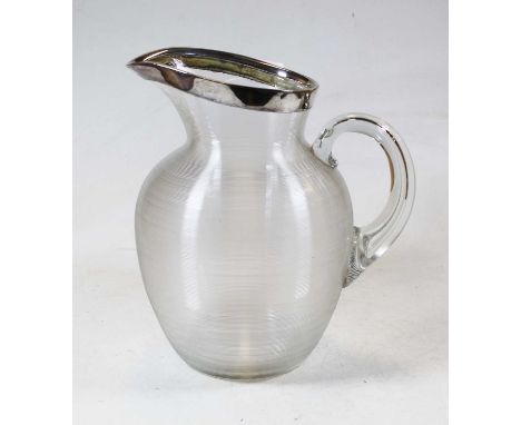 A large ribbed glass pitcher having white metal rim, height 25cmCondition report: Metal rim good other than very light tarnis