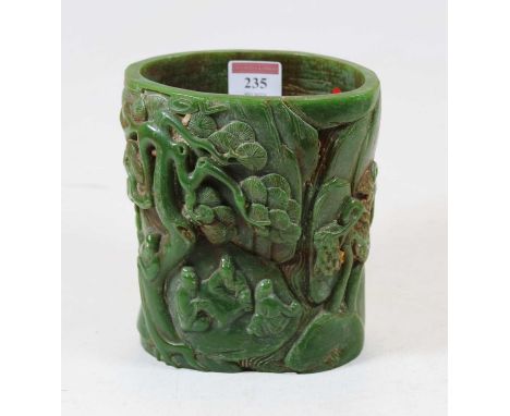 A Chinese jade coloured brush pot, carved with various figures amid trees, with seven character mark, height 15.5cmCondition 