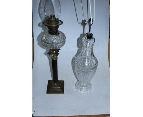 An early 20th century oil lamp, having clear cut glass font, on a Corinthian column and stepped square base; together with a 