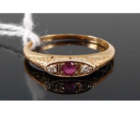 An early 20th century yellow metal, ruby and diamond three stone ring, 1.8g, size J