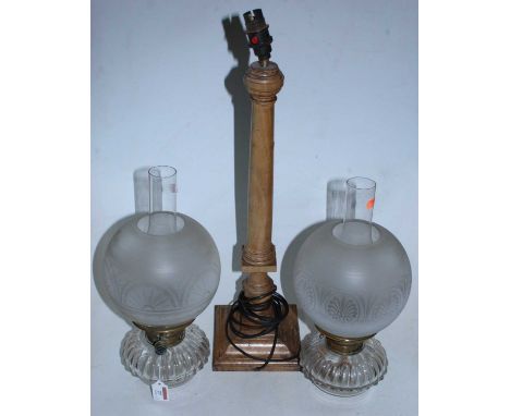 A pair of cut clear glass oil lamp fonts with Hinks Duplex burner and globular shades, together with a turned wooden table la