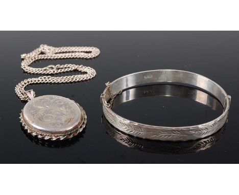 A Victorian style silver and half-engraved hinged bangle; together with a white metal and engraved picture locket on finelink
