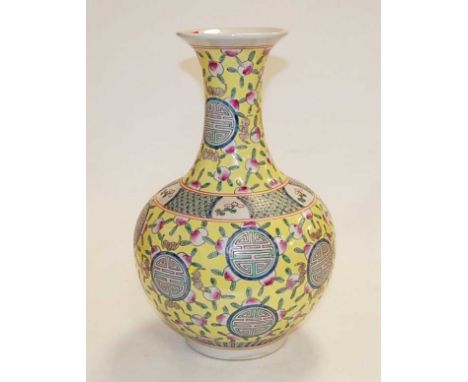 A reproduction Chinese vase having a flared rim to a slender neck and bulbous lower body, on a yellow ground with enamelled r