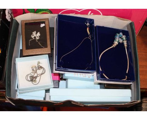 A collection of assorted modern jewellery, mainly being in Indulgence boxes, to include white metal torque bangle surmounted 