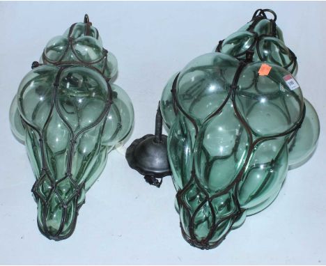 A matched pair of iron framed and green tinted bubble glass ceiling light fittingsCondition report: Metal work has some signs