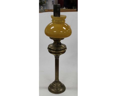 A large brass range kettle together with a brass oil lamp with yellow tinted glass shade and a continental boat shaped vase (