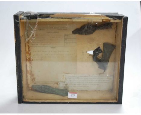 A glazed display containing three ancient axe heads, probably Bronze Age, with related report from the Colchester &amp; Essex