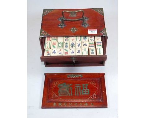 An early 20th century mah-jong set in fitted five drawer case, having bone tiles and counters, with a Pan Mah-jong guide book