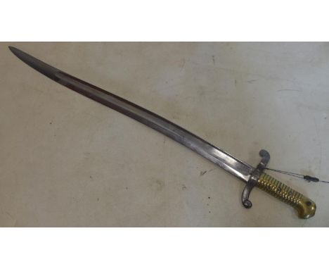 A French 1842 Yataghan bayonet with steel scabbard, bearing various markings and inscriptions to handle and blade 