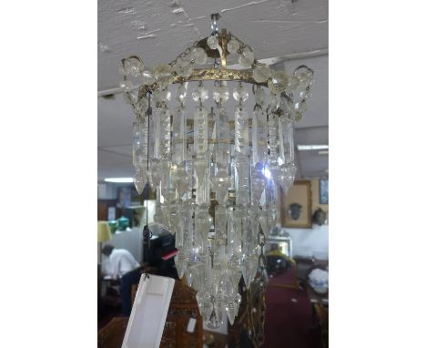 A gilt metal and glass drop chandelier together with a pair of matching wall lights 
