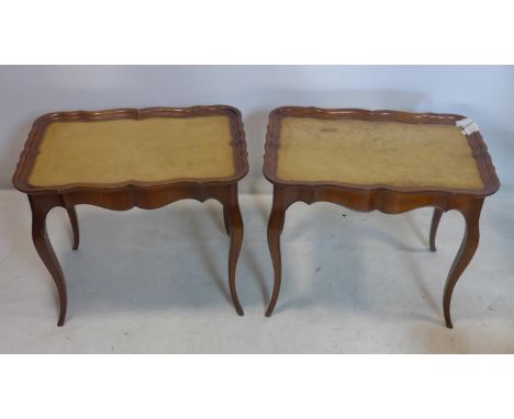 A pair of walnut lamp tables with vinyl tops, H.59 W.69 D.46cm 