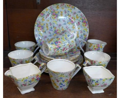 A Royal Winton Fireglow Chintz tea service comprising one large plate, five medium plates, four saucers, six cups, a sugar an