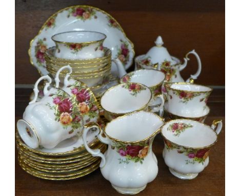 Royal Albert Old Country Roses teaware comprising a cake plate, tea pot (lid a/f), nine cups and saucers, six medium side pla