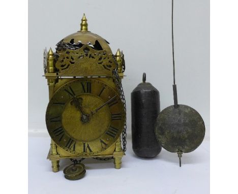 A late 19th Century, brass lantern clock with weight and pendulum