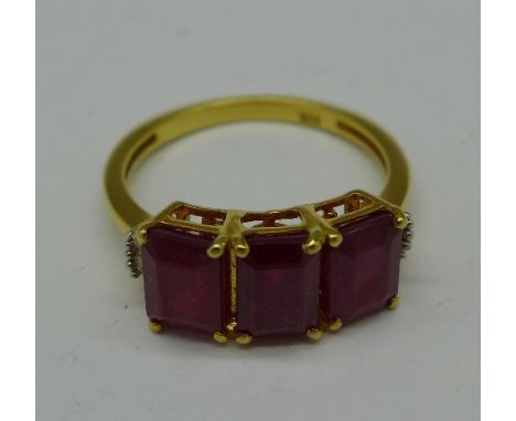 A silver gilt, ruby and ten diamond ring, O