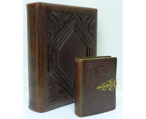 Two Victorian leather embossed photograph albums, the small album with portrait photographs, the larger one empty