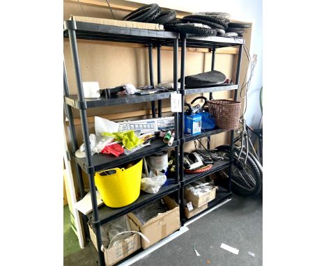 A pair of black plastic shelving units, with contents, including a quantity of child's bike tyres, a yellow plastic twin hand