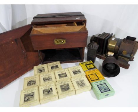 A Magic Lantern with accessories marked Primus, and a cabinet containing a good collection of Primus slides with subjects to 