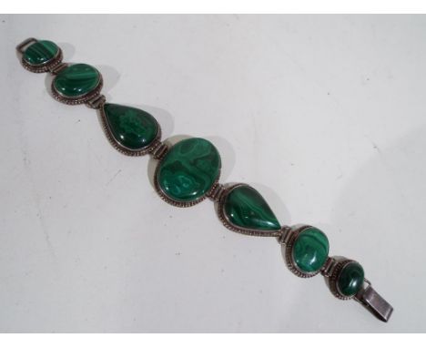 A vintage silver bracelet set with malachite, approximate length including clasp 22 cm, largest stone, including silver surro