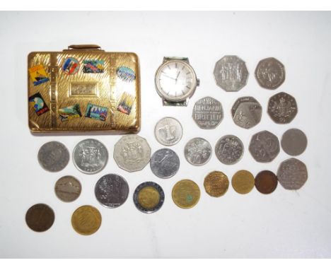 A small quantity of UK and Foreign coins also included in the lot is a yellow metal powder compact in the form of a suitcase 