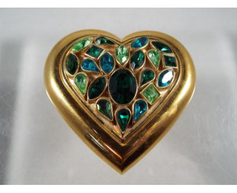 Yves Saint Laurent - an Yves Saint Laurent powder compact in original box, a heart shaped gold colored compact set with stone