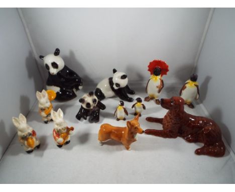 A quantity of ceramic animal figurines to include Beswick Corgi, Beswick Penguins, Goebel Panda, Russian Pandas, Beswick Red 