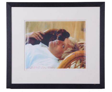 A signed photograph of David Hockney by an unknown photographer, ca. 1980s, together with a signed copy of the exhibition cat