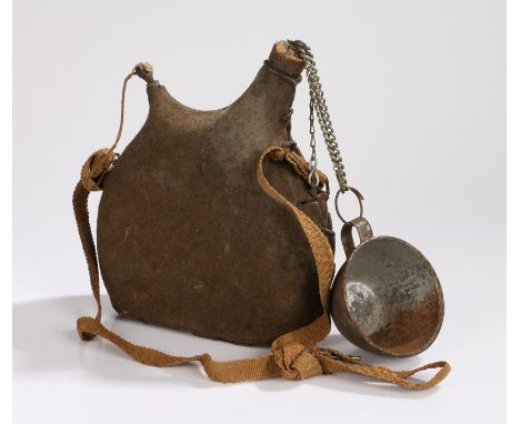 First World War French water bottle, green cloth covering, complete carrying strap and stopper cork to which tin mug is attac