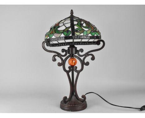 A Tiffany Style Table Lamp on Bronzed Supports, 51cms High 