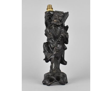 A Chinese Carved Wooden Lamp Base in the Form of a Chinese Elder, 58cms High 