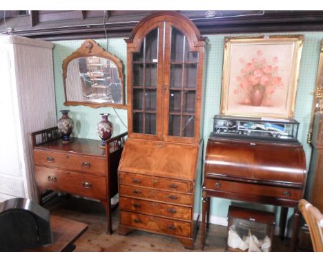 An early 20th century mahogany and inlaid bureau bookcase, the domed top over twin glazed doors, the fall over four graduated
