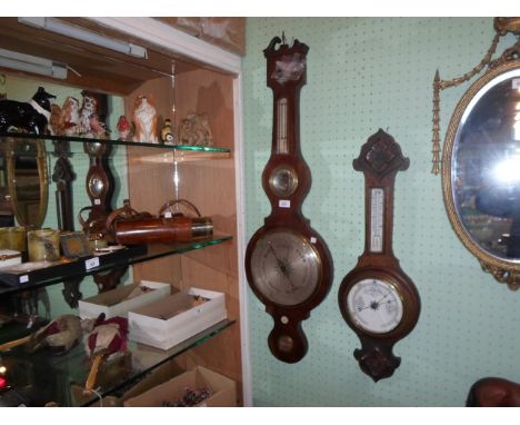 A mahogany cased banjo barometer signed C. Canti, London, (104cm), together with an oak carved banjo barometer.