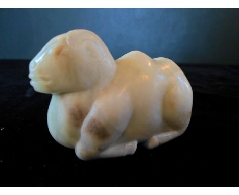 A Chinese mutton fat jade carved figure of a recumbent animal, (6.5 x 5 x 2cm).