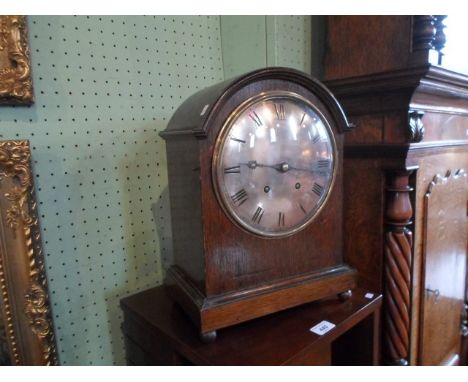 A 20th century domed top mantle clock, the coil striking movement signed W & H, silvered dial bearing Roman numerals on four 