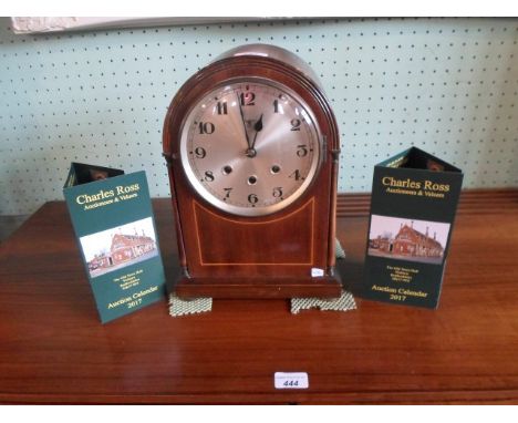 An early 20th century mahogany and inlaid dome topped chiming mantle clock, the silvered dial bearing Arabic numerals, (35cm)