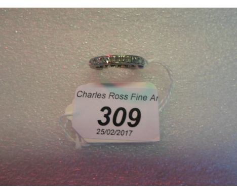 A diamond eternity ring, the brilliant cut diamonds in claw set channel with engraved mount.   Condition Report:  Ring size c
