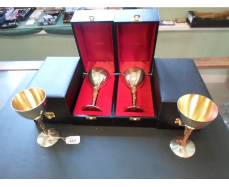 A set of four Stuart Devlin silver and gilt goblets, each in presentation box, (15cm), London hallmarks 1978.   Condition Rep