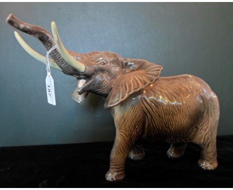 A large Beswick Elephant, 'Trunk Stretching', modelled in the 1970's, no. 998, gloss finish, (26cm tall).