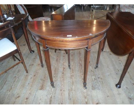 An Edwardian demi-lune mahogany and inlaid fold-over card table, (92cm wide).