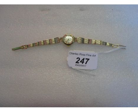 A lady's 9 carat gold cased Rotary wristwatch, the champagne dial bearing baton numerals to a 9 carat gold bracelet.   Condit