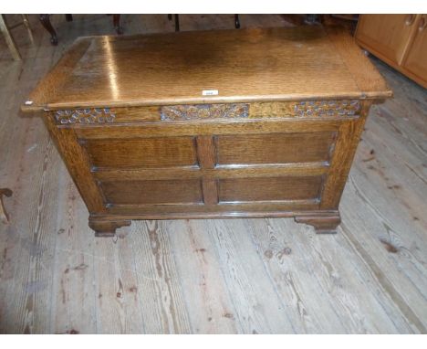 An early 20th century oak coffer on bracket feet, (91cm wide).