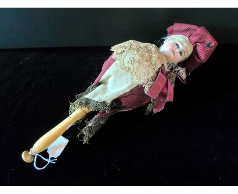 A late 19th/early 20th century musical bisque headed Marotte doll, having blue glass eyes, dressed in a red and cream sailor-
