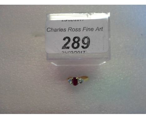 A ruby and diamond ring, the oval cut ruby flanked by two diamonds to an 18 carat gold shank, stamped 750.