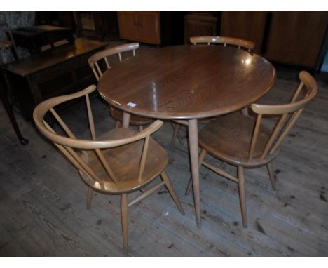 A 1959 retro Ercol dining table and four conforming stick back chairs, one carver and three standard, (the table 99cm x 89cm)