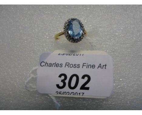 An aquamarine and diamond cluster ring, the oval cut aquamarine in raised claw mount above a border of single cut diamonds to