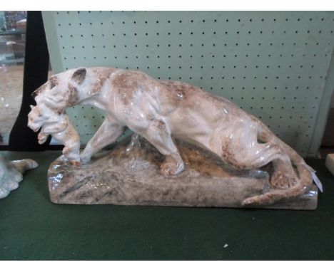 A large 20th century ceramic model of a lioness, with a cub in her mouth, (58cm x 30cm).
